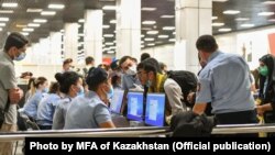 Ethnic Kazakhs arrive at Almaty airport from Kabul in September.