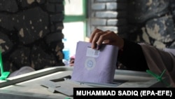 An Afghan man casts his vote during the parliamentary elections in Kandahar in October 2018.