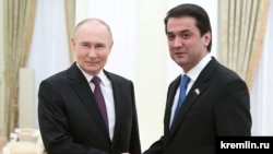 Russian President Vladimir Putin (left) and Rustam Emomali, the son of Tajik President Emomali Rahmon meet at the Kremlin. (file photo)