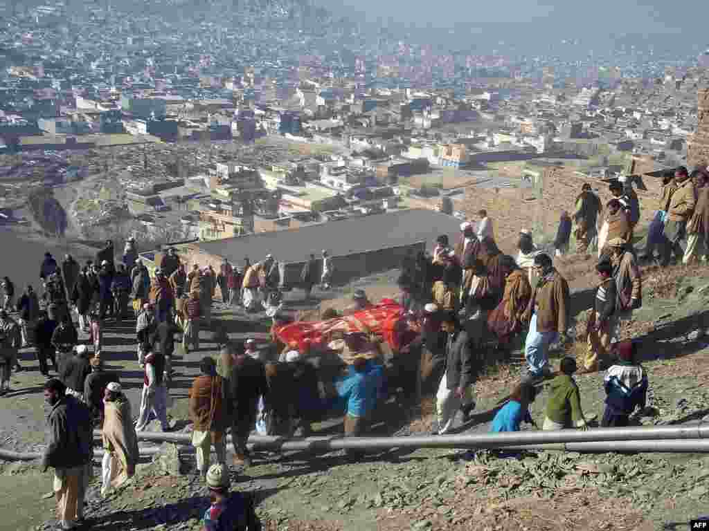 People carry the coffin of a bombing victim in Mingora.