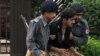 Pakistani police officers help an injured colleague after a suicide attack in Islamabad