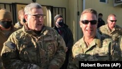 Chairman of the U.S. Joint Chiefs of Staff General Mark Milley (left) talks with General Scott Miller, the commander of U.S. and coalition forces in Afghanistan, at Miller’s military headquarters in Kabul on December 16.