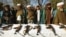 Afghanistan -- Taliban fighters stands near their weapons after they joined government forces during a ceremony in Herat, 29Dec2011