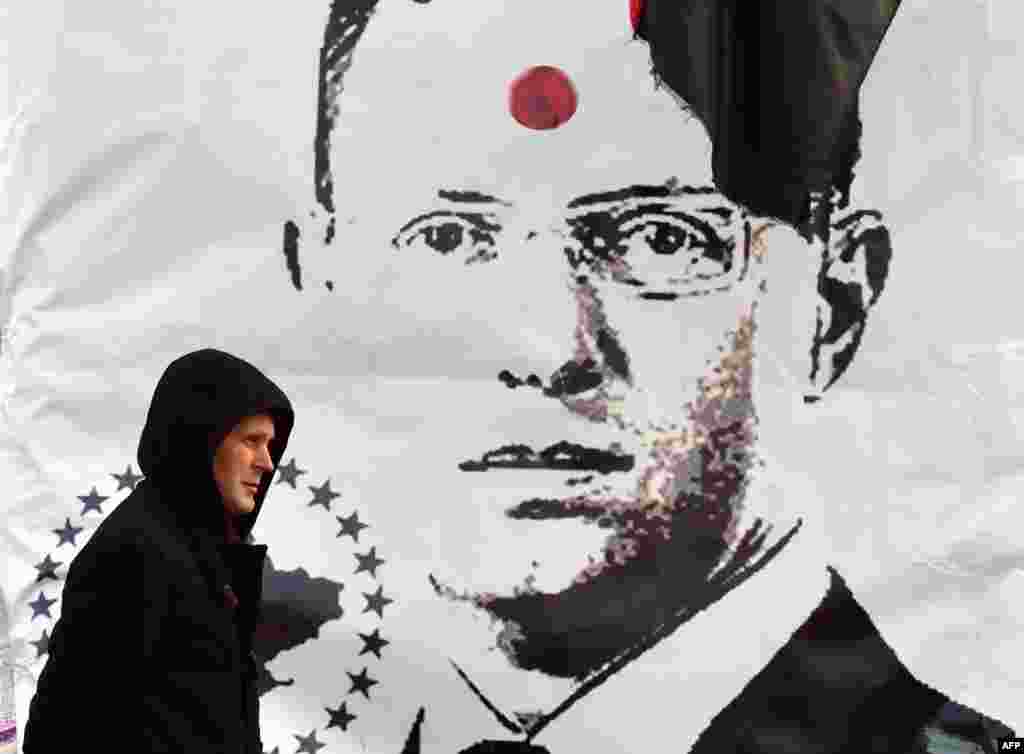 Плакат, вывешенный противниками правительства Яценюка на Майдане. Красная точка на лице премьера - напоминание о его фразе о готовности получить "пулю в лоб", произнесенной в разгар уличных боев в Киеве в феврале 2014 года.  